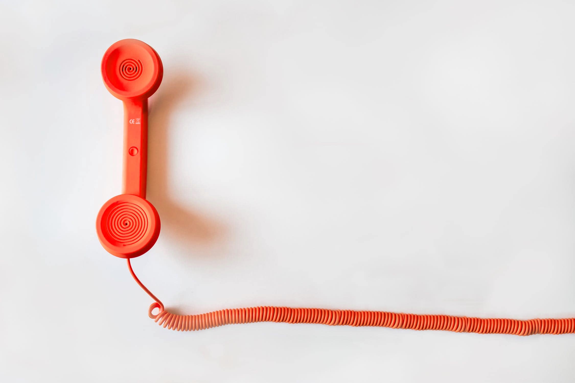 Orange telephone on a white background